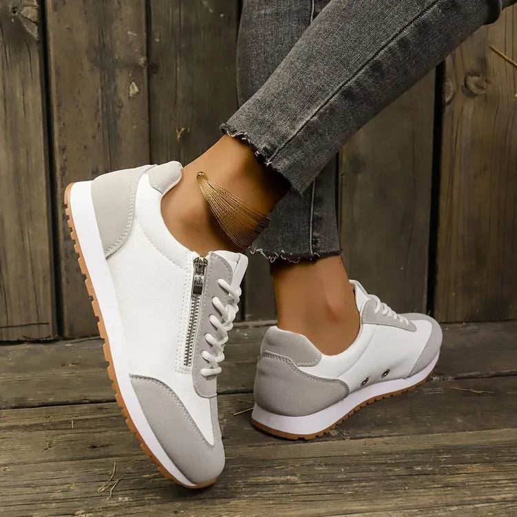 Women's flat-heeled ballet pumps in grey, white, and champagne with a PU upper and rubber sole.