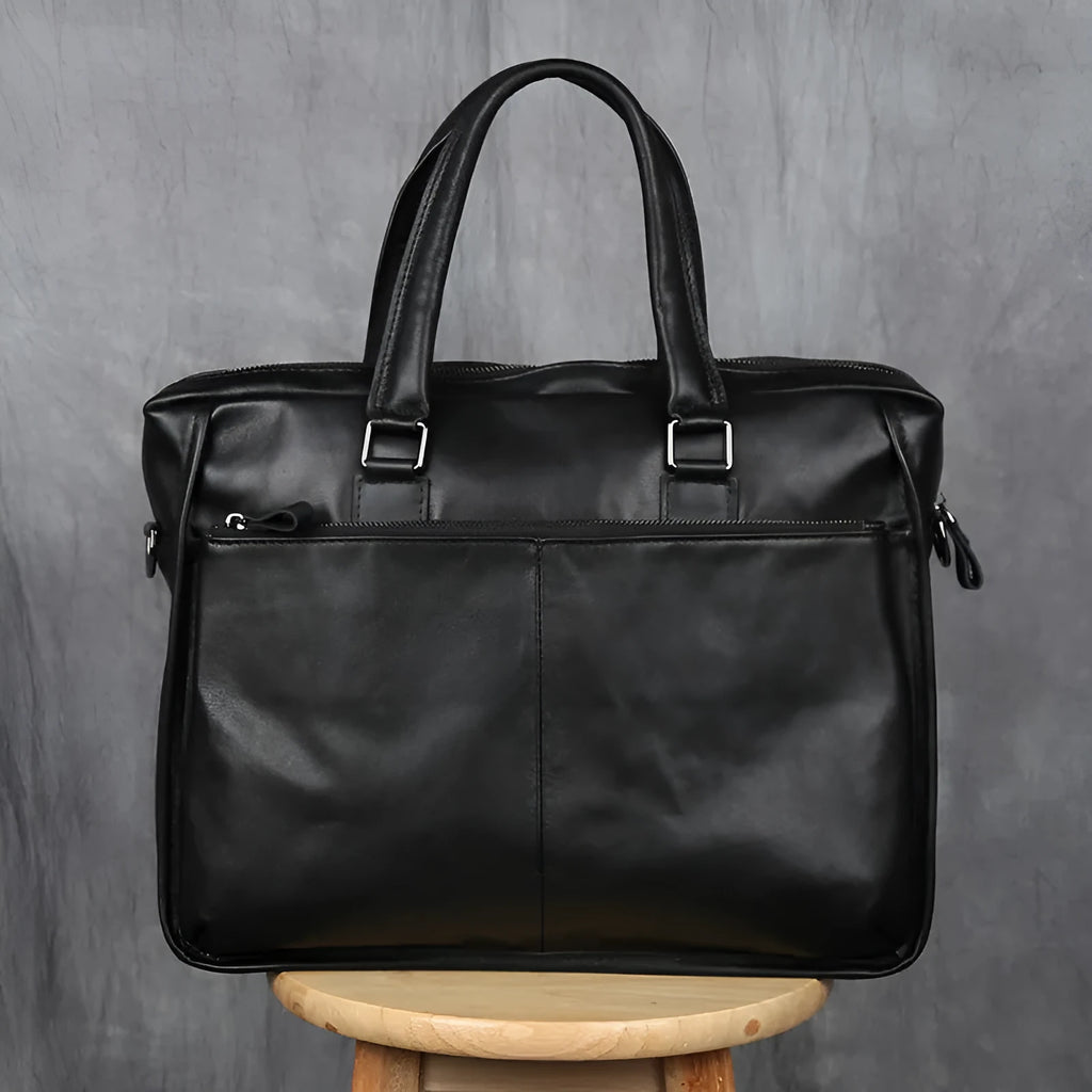 Black men's leather leisure briefcase with top layer cow hide, zipper closure, and shoulder strap