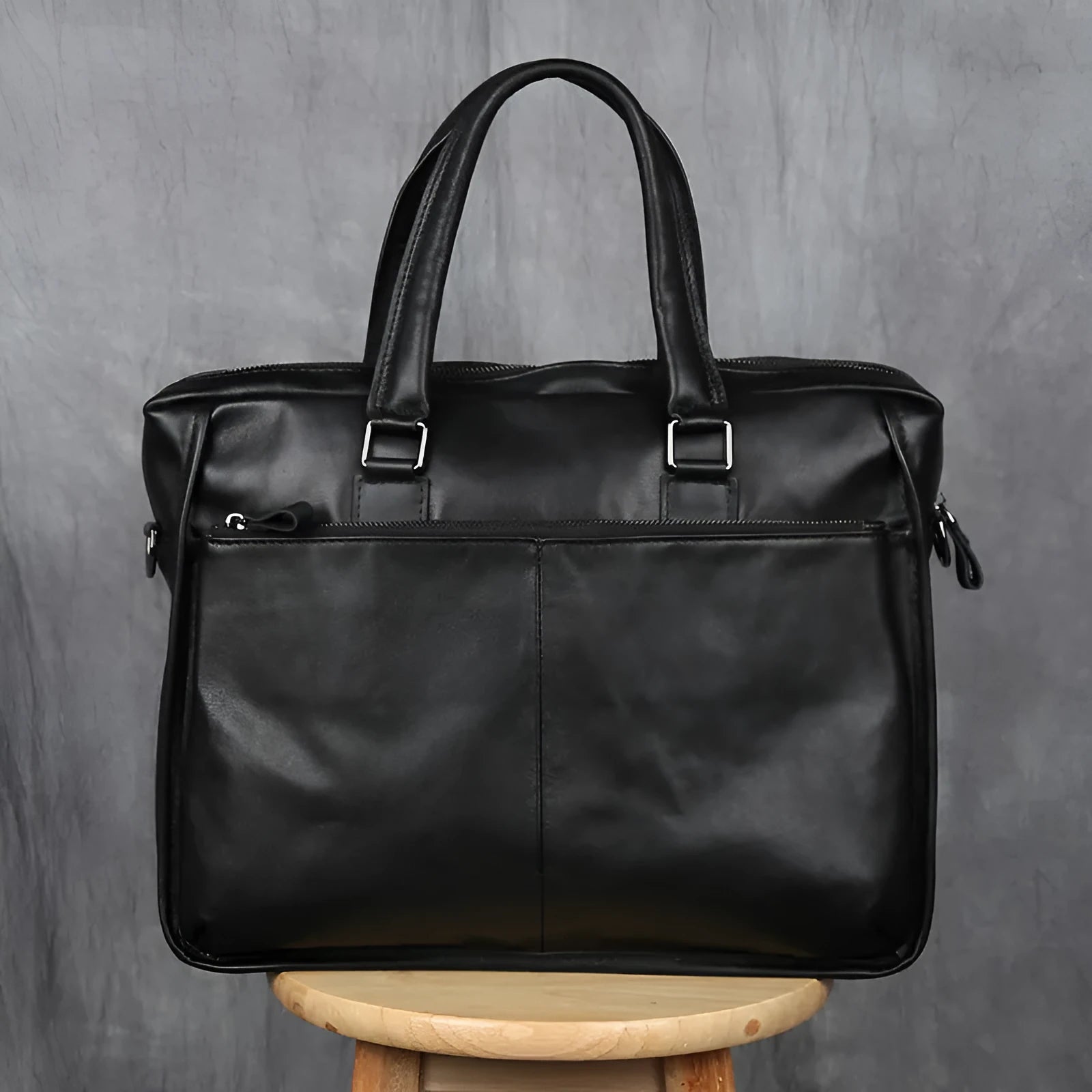 Black men's leather leisure briefcase with top layer cow hide, zipper closure, and shoulder strap