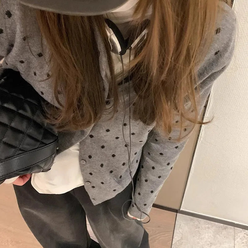 Grey Korean-style women's cardigan with white crocheted flower details on a mannequin.