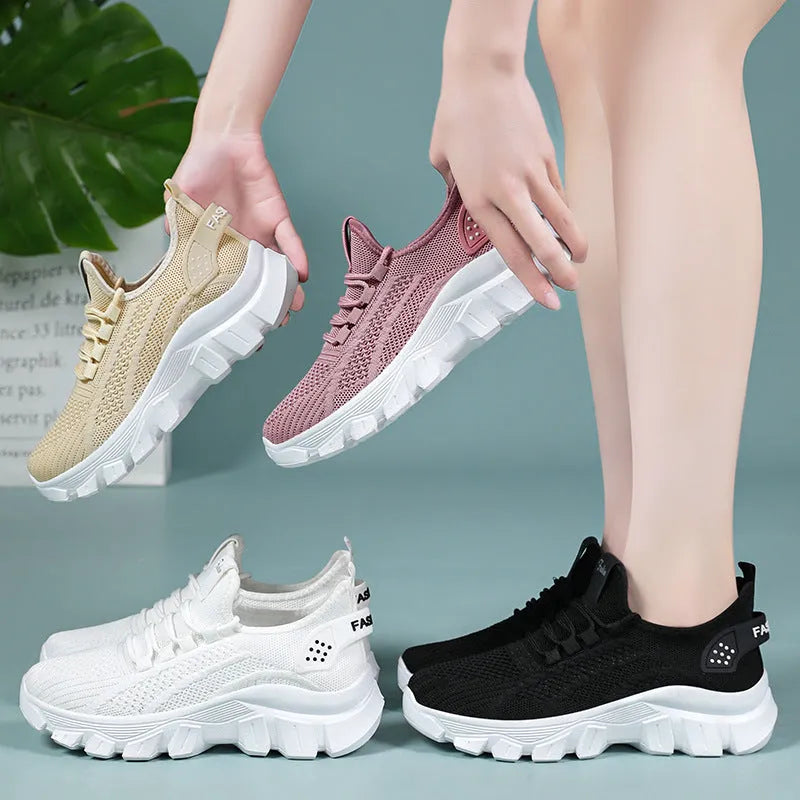 Women's white Flyknit running shoes with a thick PVC sole and lace-up front.