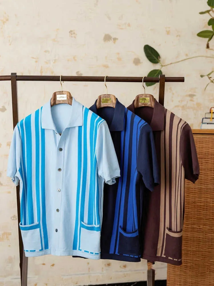 Royal blue striped short-sleeve polo cardigan with a lapel collar on a hanger.
