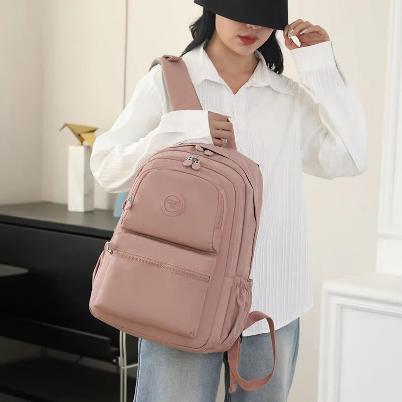Women's large capacity multi-layer travel backpack in Zhu Mo Black, made from waterproof nylon