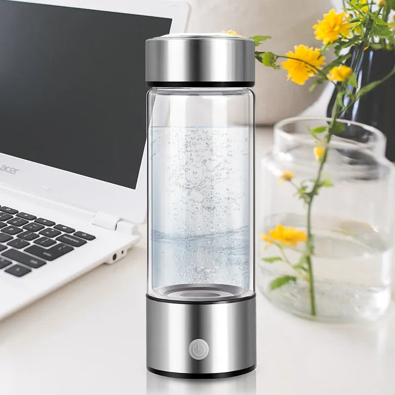 Hydrogen water bottle in silver with electric base, borosilicate glass body, 21.5cm tall, 401-500ml capacity
