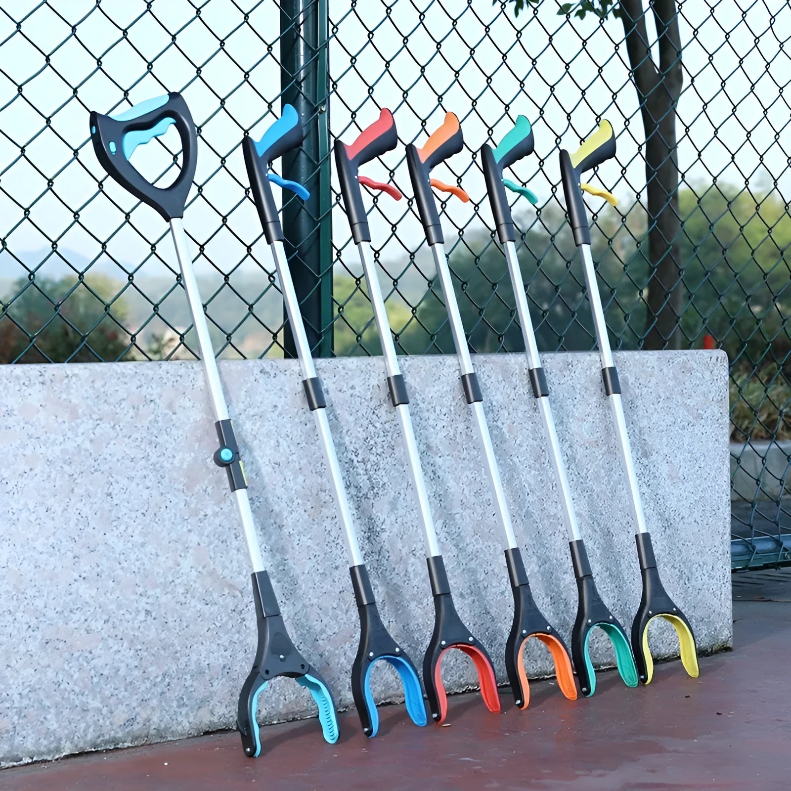 Sewer pliers and trash clip tool with coloured plastic handle and metal jaws.