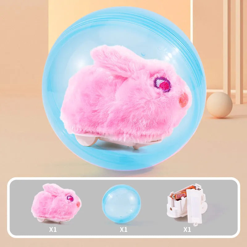 Hamster rolling ball toy set with transparent plastic sphere, plush shell in beige, and battery base on a floor