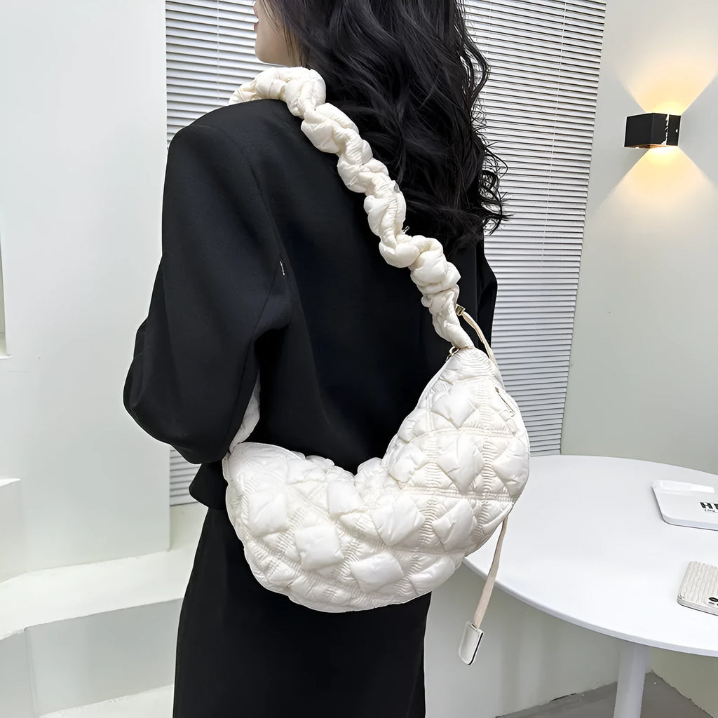 Women's light beige nylon underarm messenger bag with a long shoulder strap.