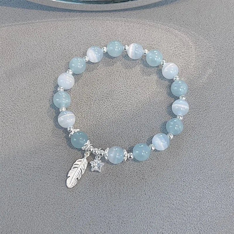 Small white girl crystal bracelet in Feather XINGX Blue Moonlight with eight Awn star and text design