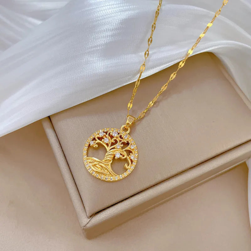 Gold-plated necklace with rhinestone lucky tree pendant featuring mother-of-pearl shell accents on stainless steel chain