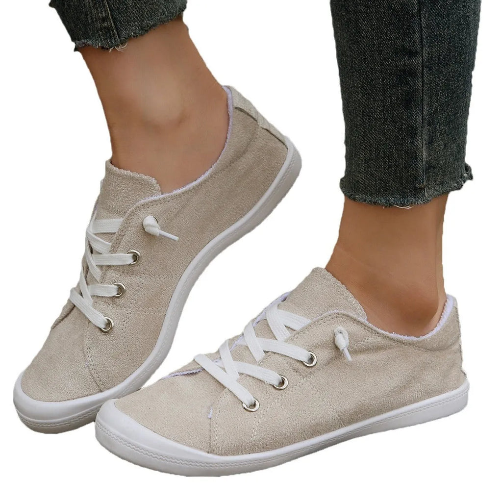 Women's beige casual sneaker with fabric upper and rubber sole on neutral background