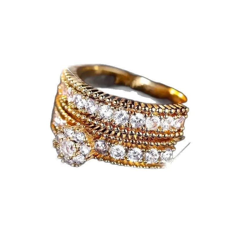 Two gold geometric zinc alloy rings with electroplated finish on white background