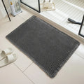 Square checkered pattern bathroom mat on tiled floor in a neutral beige colour.
