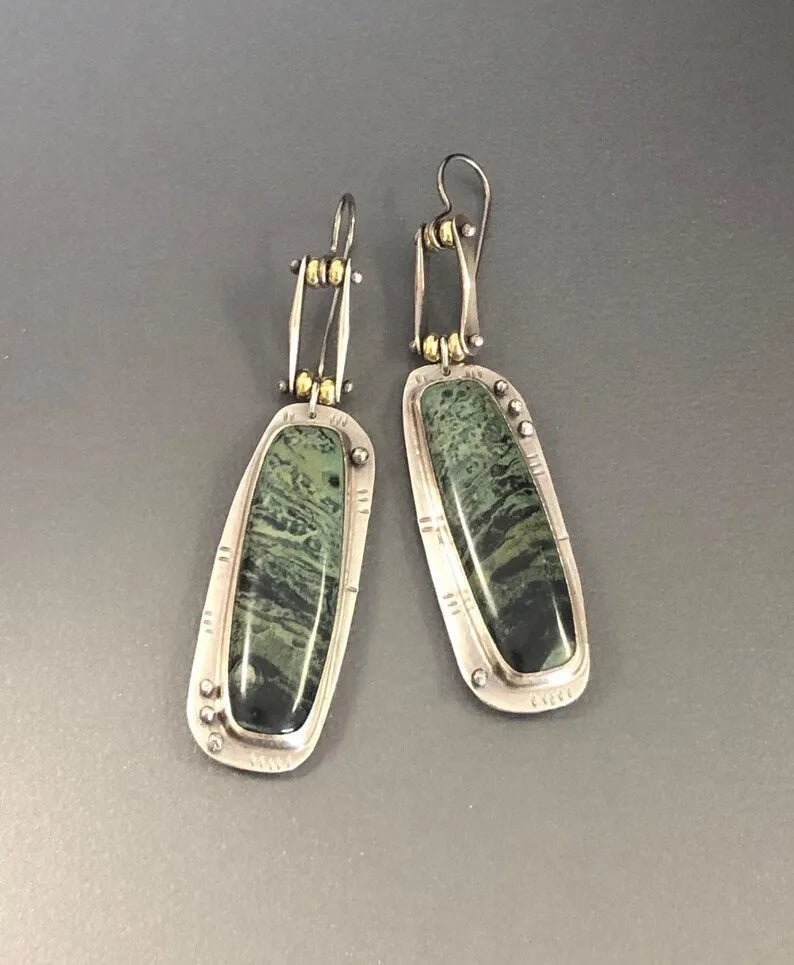 Simple geometric alloy earrings with a two-colour marble pattern and stainless steel posts.