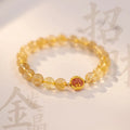 Natural citrine gold rutilated quartz diamond cut bracelet 6mm beads on neutral background