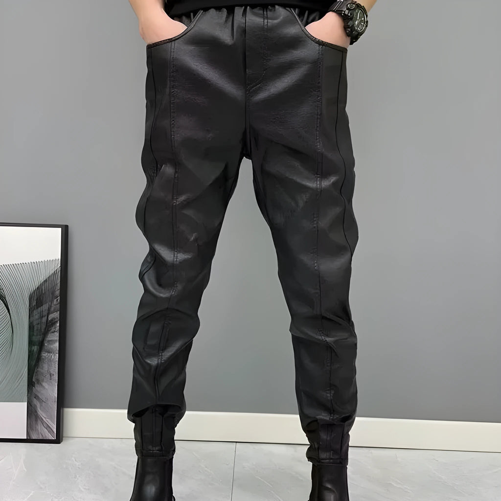 Black PU leather motorcycle takeaway pants with cuffs, tapered leg, and mid-rise waist, on a model