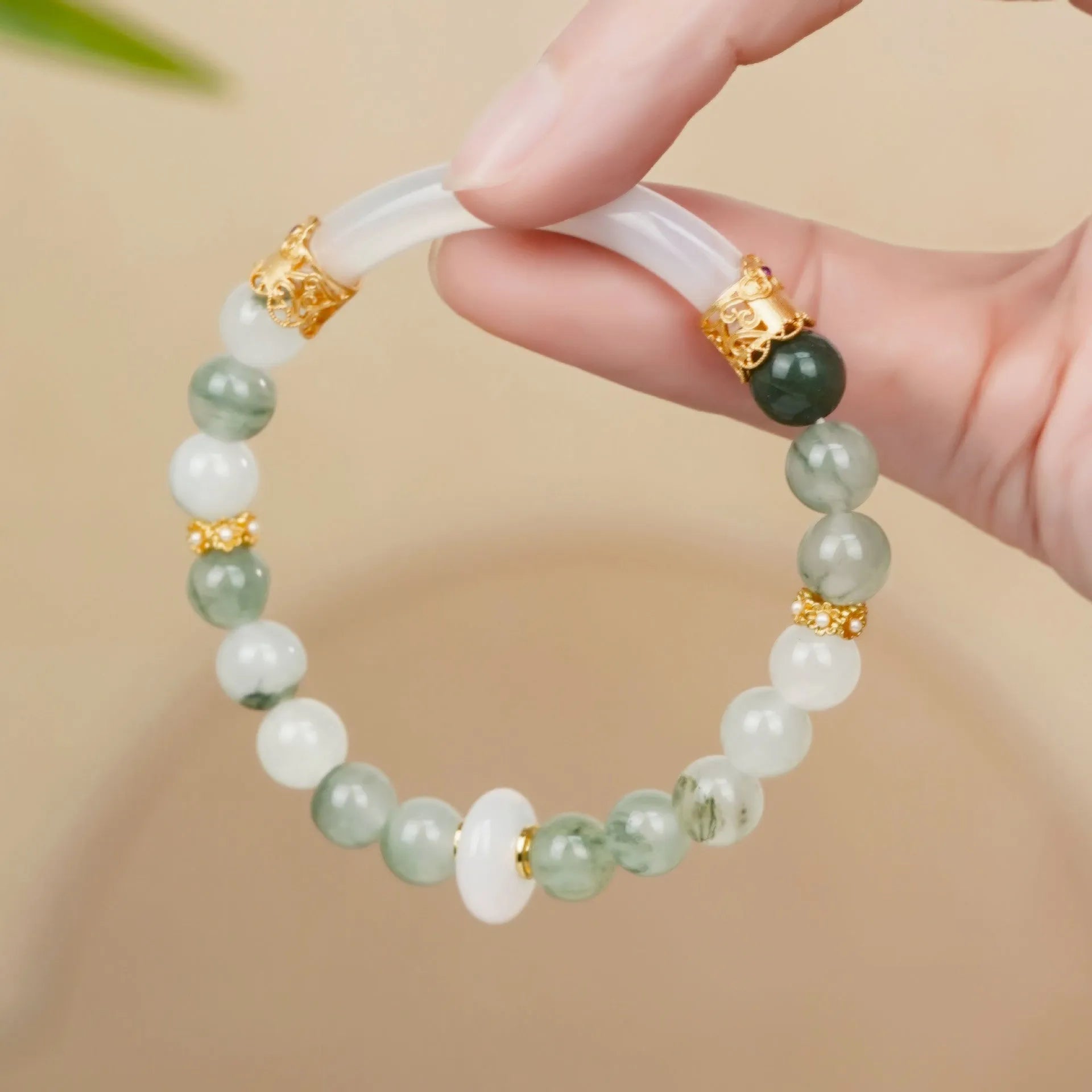 Emerald green Tian Shan Cui half bracelet with floating flower girl design and round motif on light background