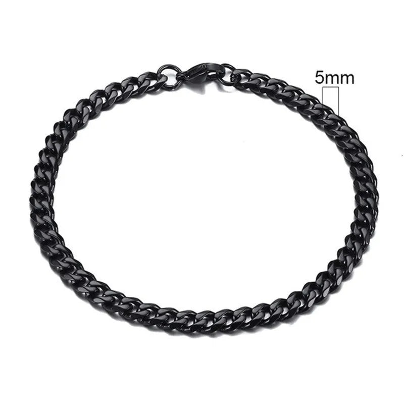 Six-sided geometric Cuban link chain metal bracelet in a gold finish on a wrist.