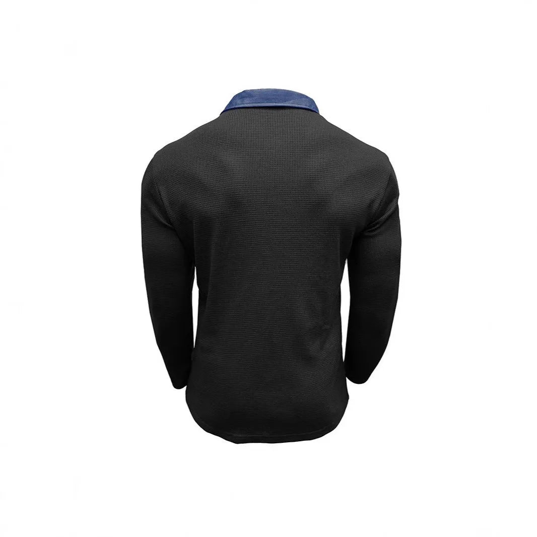 Man wearing a long-sleeved waffle texture polo shirt in a solid colour with a loose, retro fit.