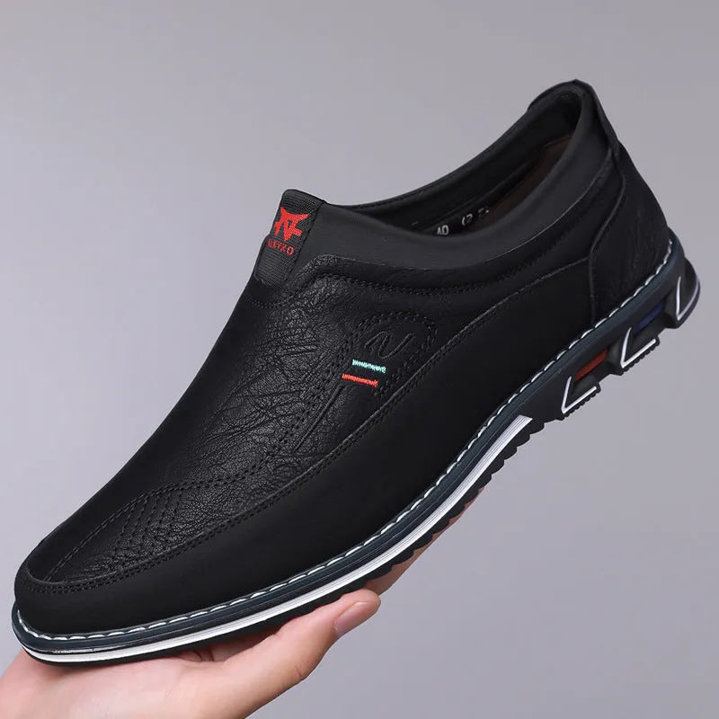 Men's black leather slip-on shoes with rubber sole and decorative sewing lines on fabric upper