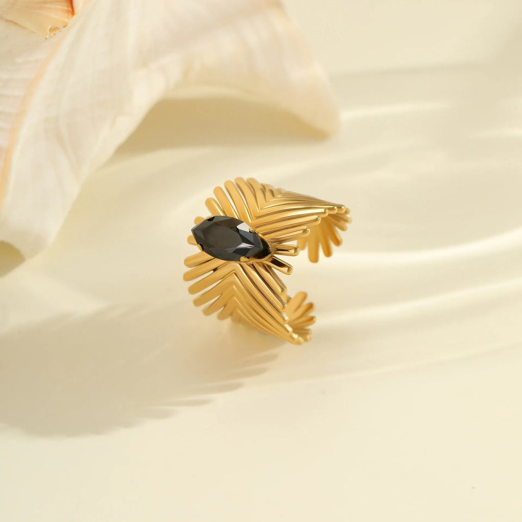 Women's adjustable titanium steel ring with geometric shape and inlaid zircon detailing on a finger.