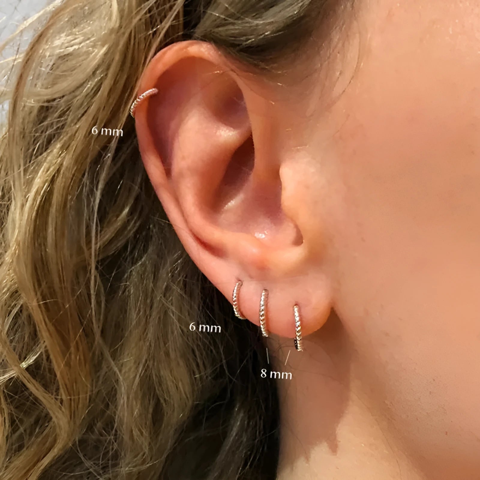 A pair of twisted string round geometric earrings made from Sterling Silver, shown in a gold electroplated finish.
