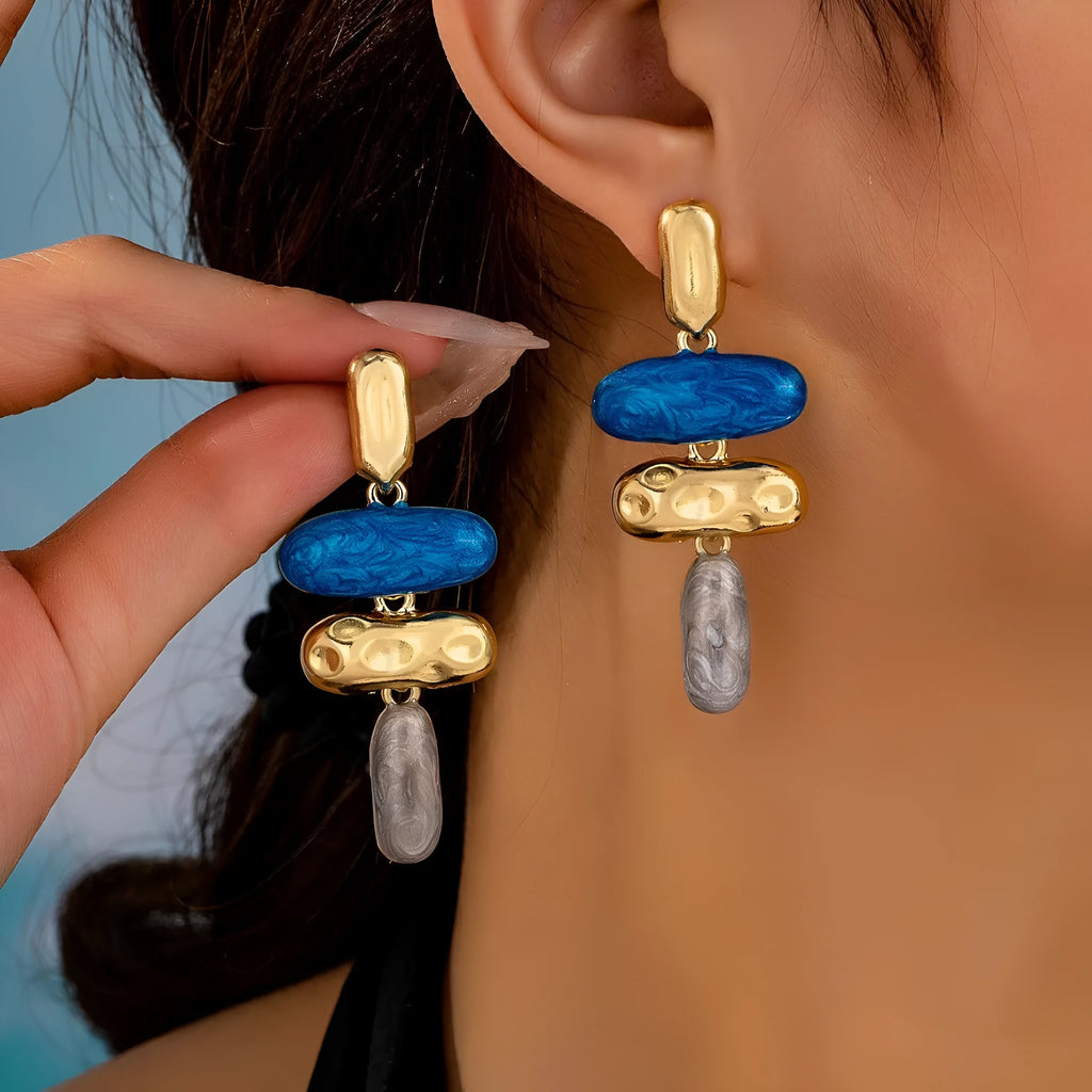 A pair of simple geometric stud earrings with a multicolour metallic electroplated finish.