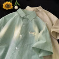 Blue and green striped plus size loose half sleeve shirt on hanger showing cardigan style
