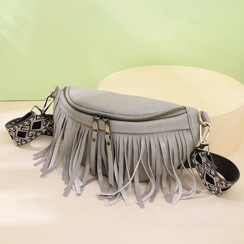 PU leather messenger bag with tassel and pleated chest design, available in multiple colours, on a plain background.