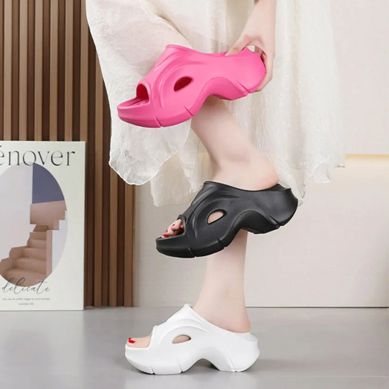 Women's thick-soled EVA slippers in rose red, white and black colours on a beach background.