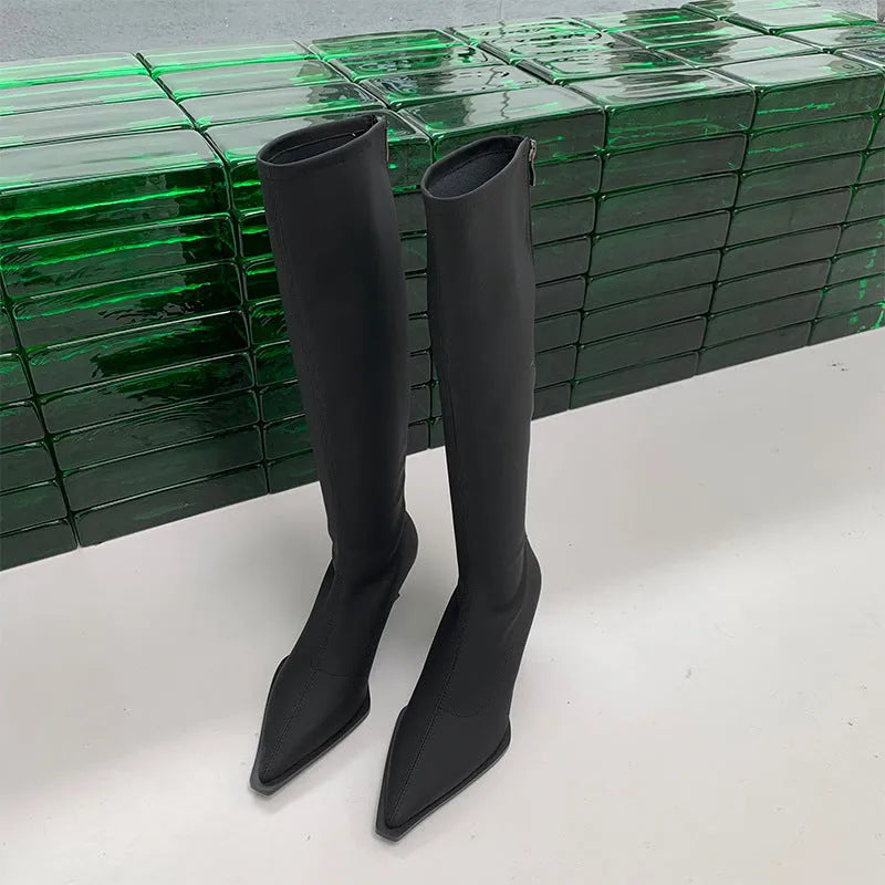 Black women's below-the-knee pointed toe stiletto boots with a back zipper on a white background
