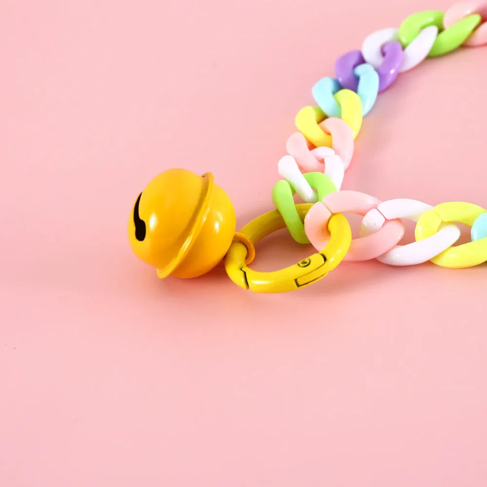 Adjustable plastic pet collar in macaron candy colours on a table, showing chain blue, pink, and mixed colour variants.