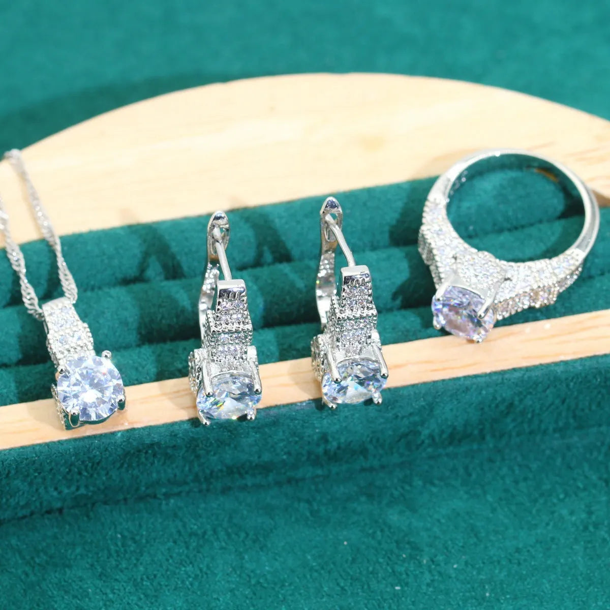 Bridal zircon jewellery four-piece set showing necklace, bracelet, earrings, and ring with water wave chain