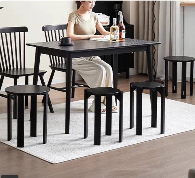 Large stackable iron dining stool in a modern style, shown in smoked black finish.