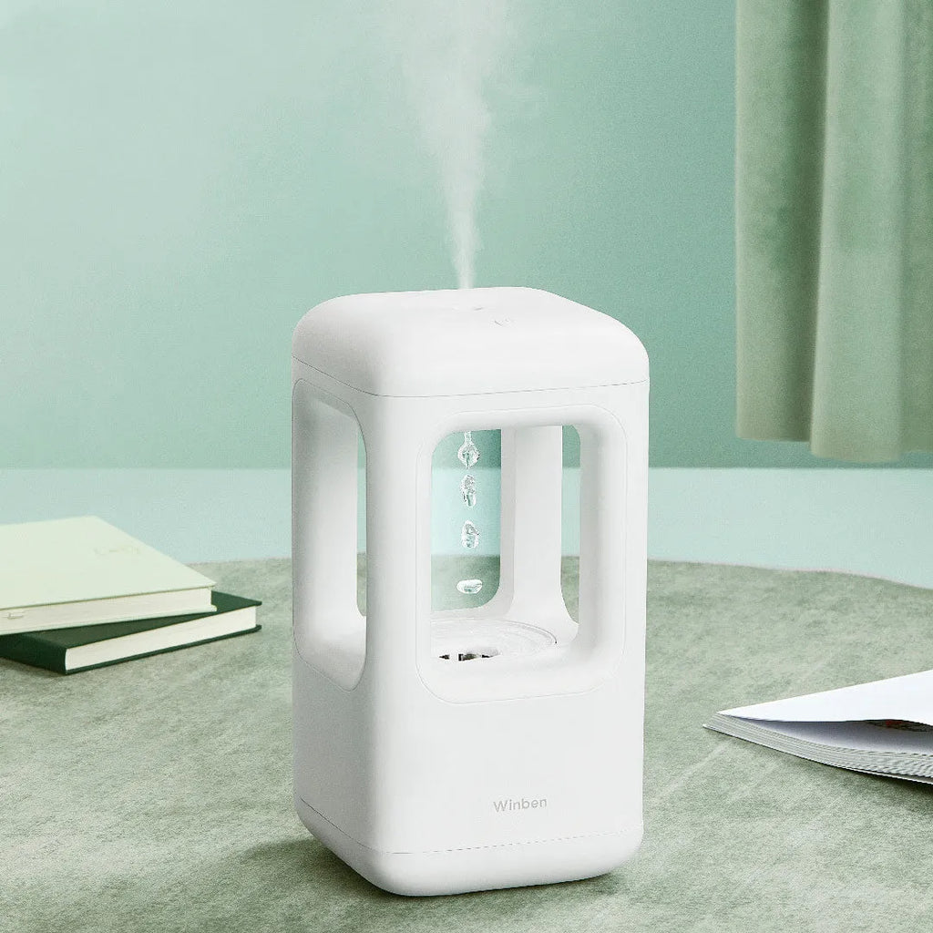White anti-gravity water drop humidifier with ambient light on bedside table