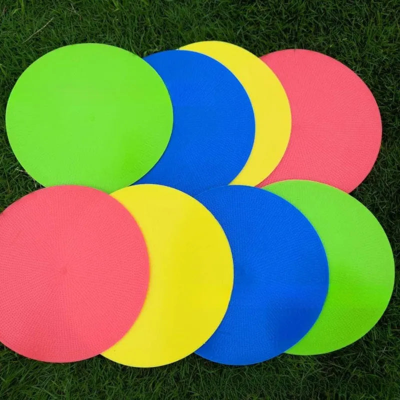 Yellow flexible TPE football training target disc, 23cm diameter, lying flat on grass.