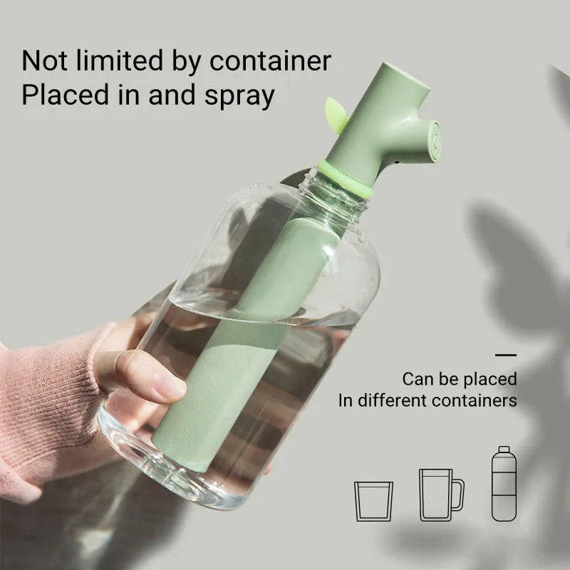 Transparent plastic mini USB branch humidifier on desk with mist output