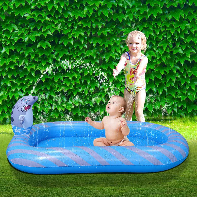 Blue inflatable dinosaur-shaped children's paddling pool with water spray play mat in a garden.