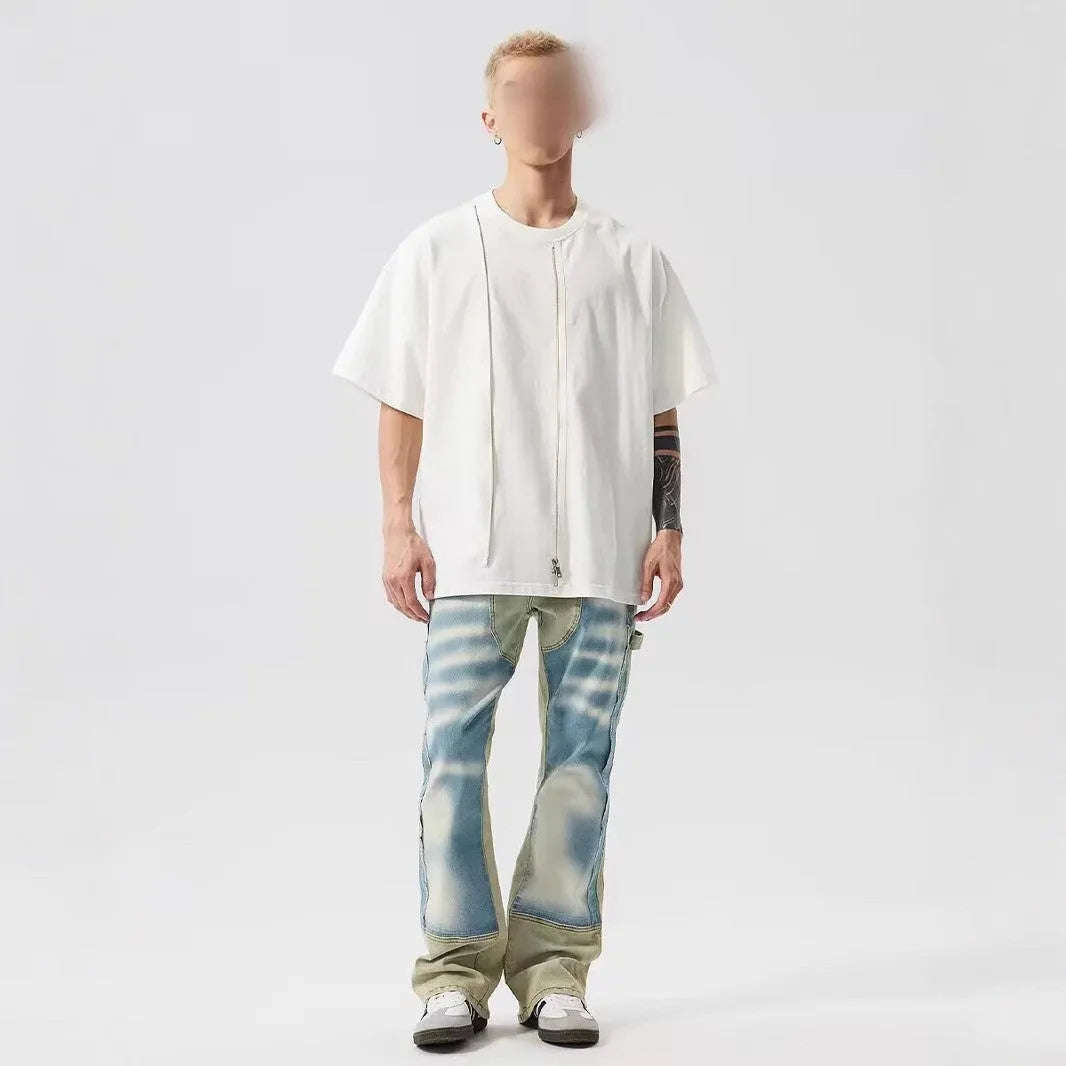 Yellow and blue retro patchwork jeans with a splash-ink damaged design, shown on a mannequin.