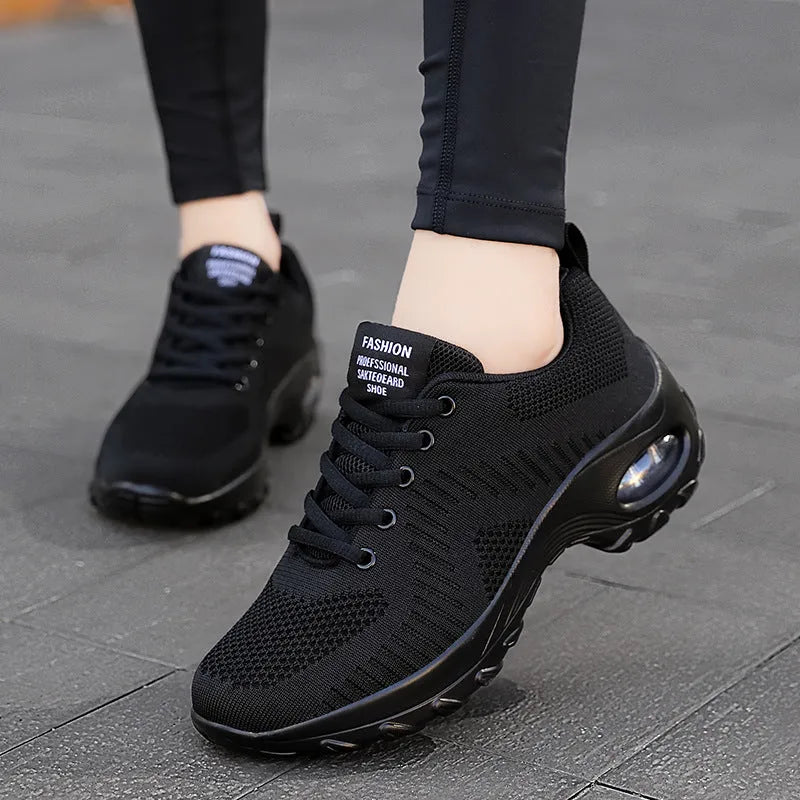 Women's black mesh sneakers with front lace-up design and round toe