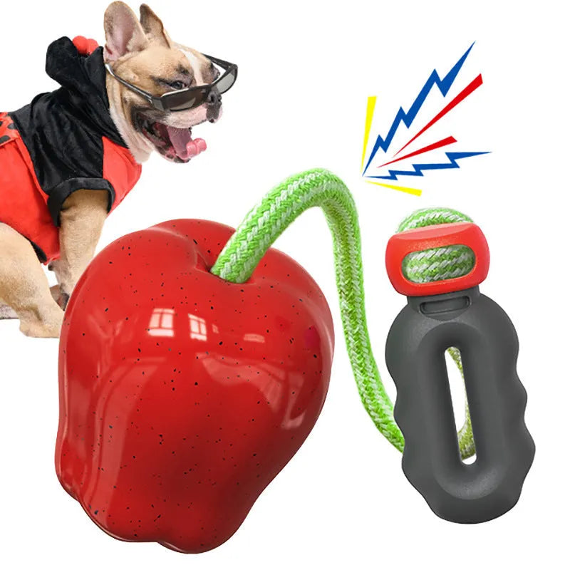 Green and red plastic apple-shaped dog toy with dropping ball for food dispensing