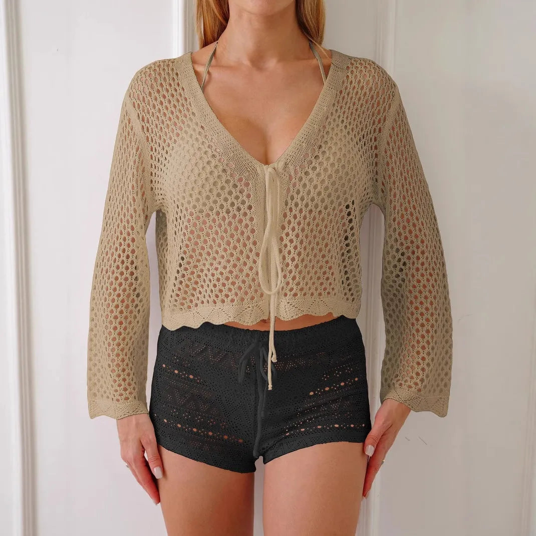 Short apricot women's cardigan blouse with bell sleeves made from thin hollow woven fabric.