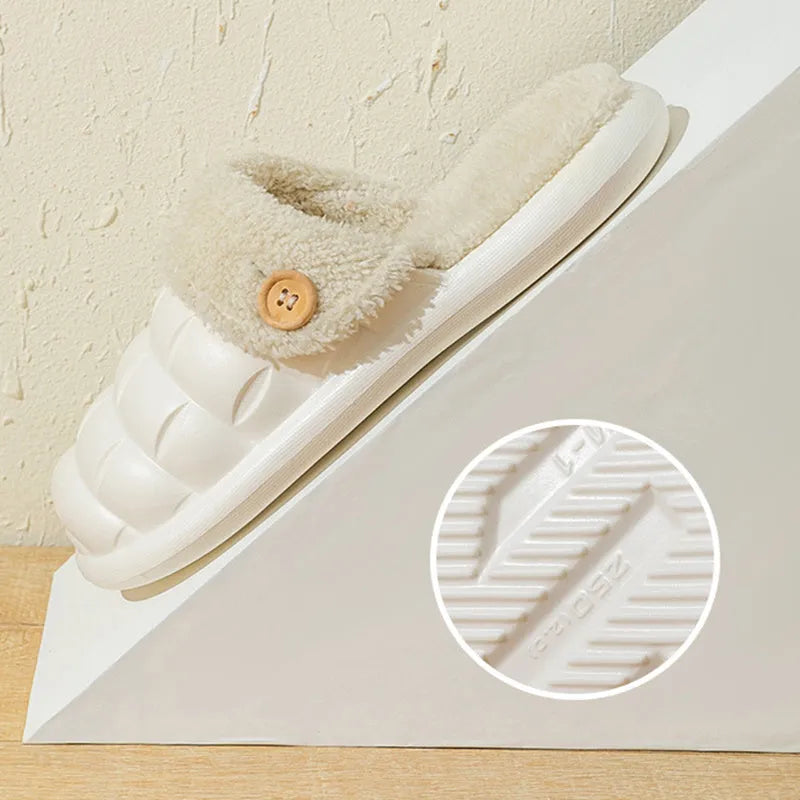 Women's pink and grey plaid EVA slippers with a detachable upper and plush lining on a wooden floor.