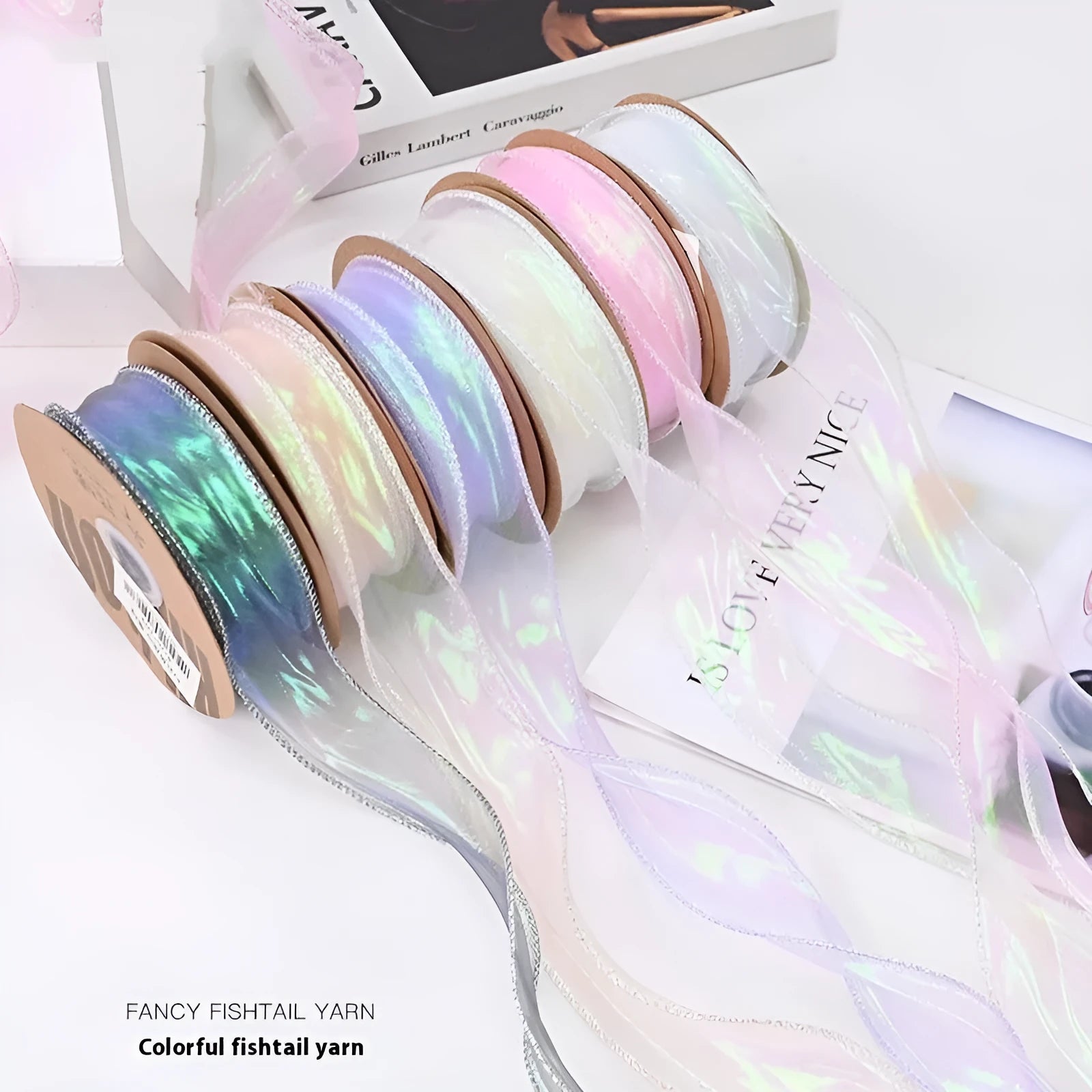 Fishtail yarn mesh ribbon roll in various illusion colours showing wave pattern and 4cm width