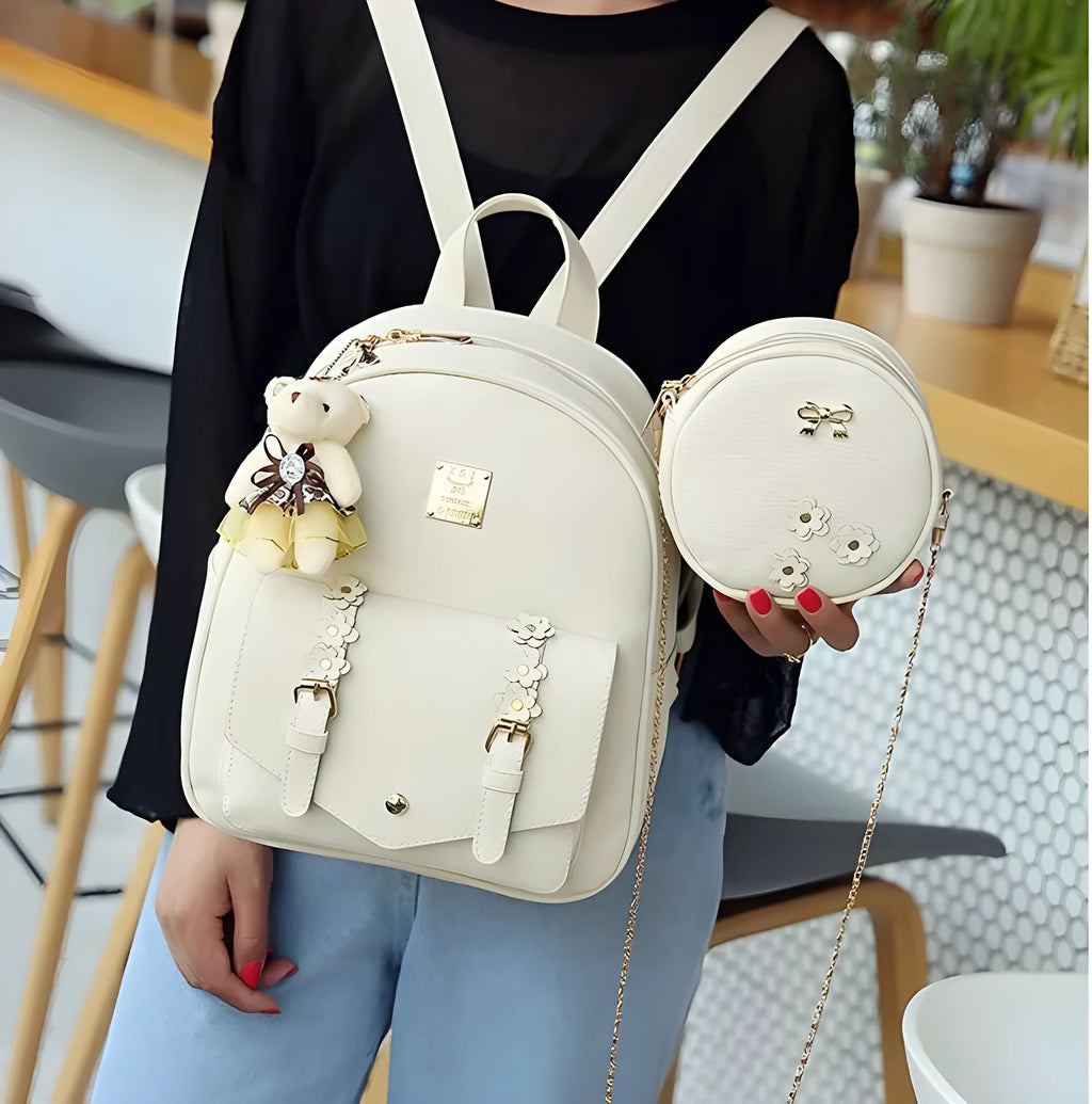 Three-piece women's bag set showing backpack, floral shoulder bag, and card holder in matching colour