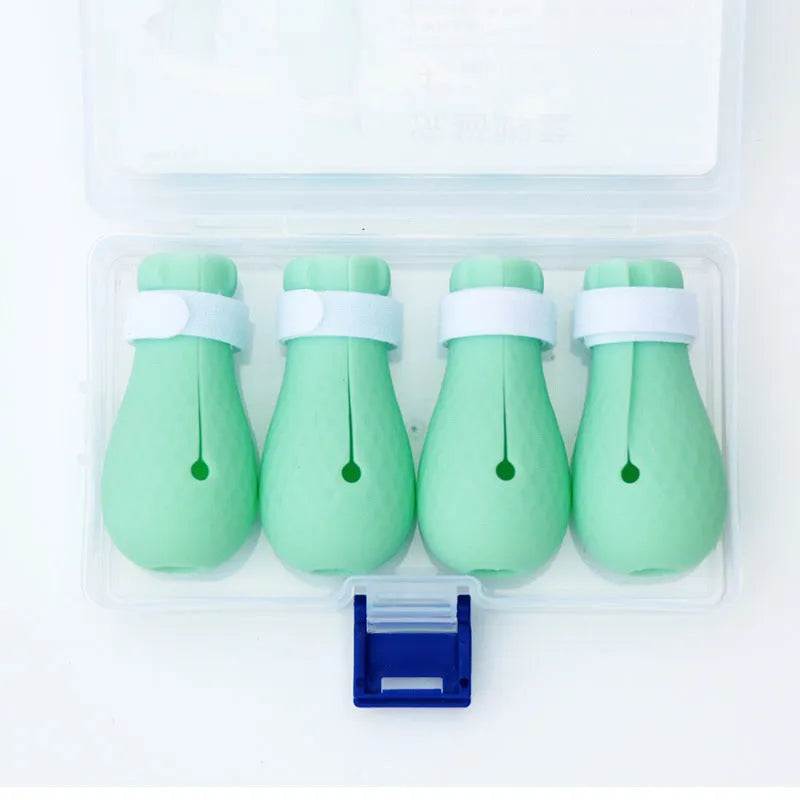Four green silicone cat paw covers designed to prevent scratching and assist with pet handling