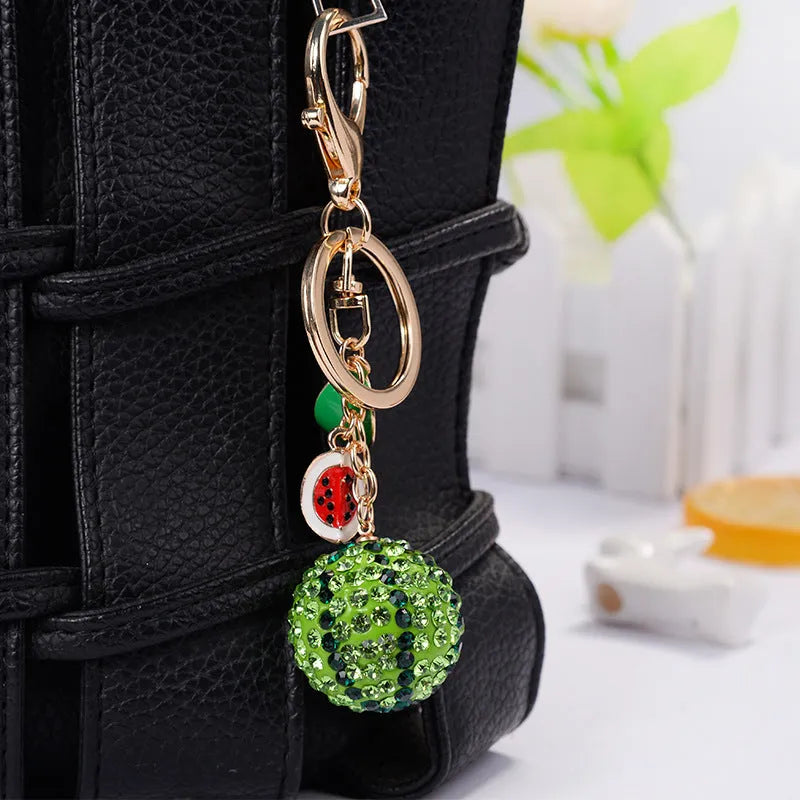Green zinc alloy watermelon shaped keychain measuring 12cm with detailed fruit design