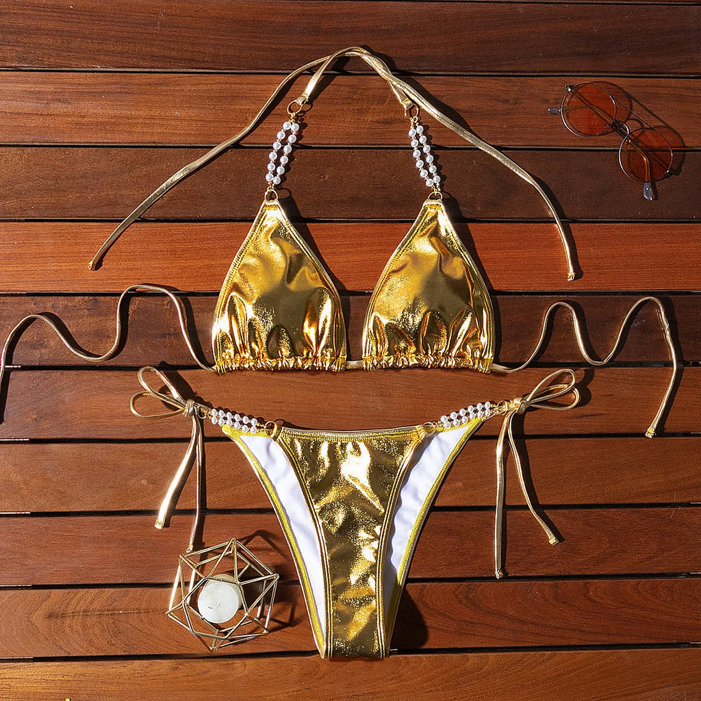 Gold halter lace-up bikini set with pearl chain detail for beach and pool wear