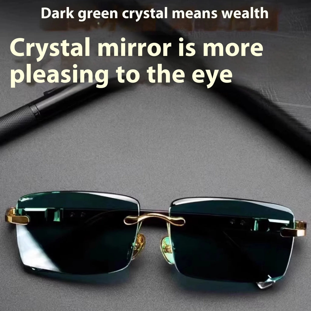 A pair of frameless rectangular sunglasses with dark green crystal lenses, a case, and a lens cloth.