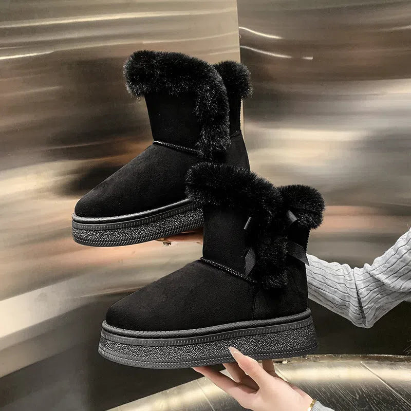 Women's mid-calf fleece-lined snow boots in brown with black rubber sole and bow tie detail