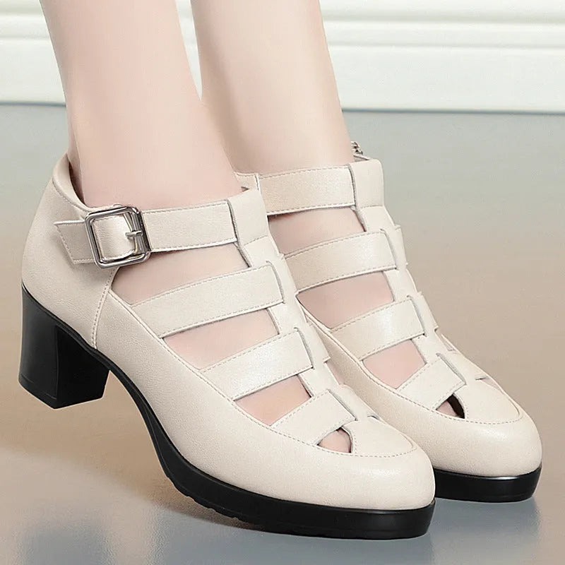 Women's beige closed toe sandals with woven upper, ankle strap, buckle, and back zipper on a chunky heel.